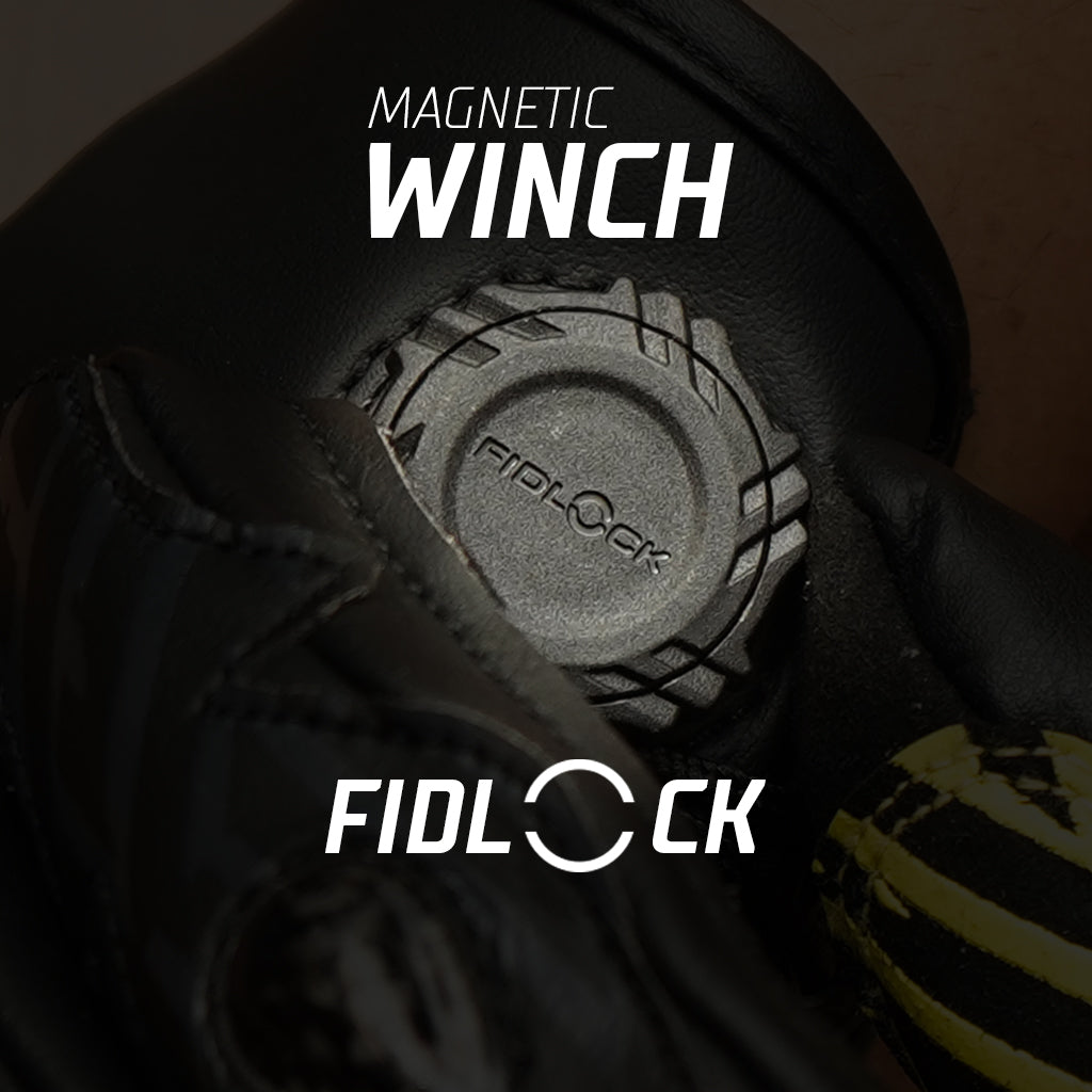 Fidlock magnetic winch with gloved hands on a dark background